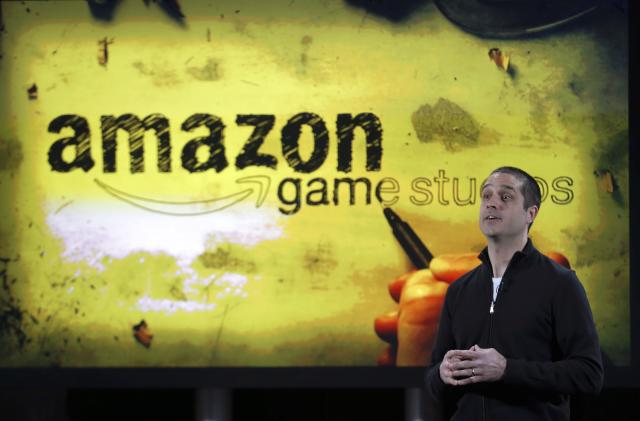 Amazon's vice president of games, Mike Frazzini speaks to media as he displays the Amazon Fire TV during a news conference in New York, April 2, 2014. Amazon.com Inc unveiled a $99 video streaming device called Fire TV that the e-commerce company promised would be more powerful and easier to use than rival services by Apple Inc, Google Inc and Roku. Amazon is a latecomer to the set-top TV market that is dominated by the Apple TV. Amazon customers have a large appetite for film and TV, but many already own similar devices, analysts said.  REUTERS/Eduardo Munoz (UNITED STATES - Tags: SCIENCE TECHNOLOGY BUSINESS)