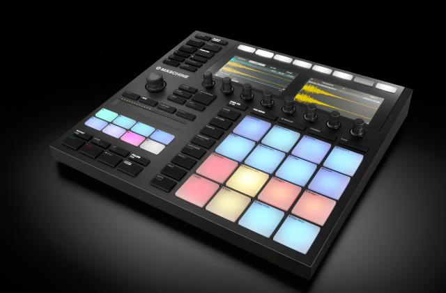Product photo of the Native Instruments Maschine MK3 all-in-one production studio. The primarily black device has colorful drum pads, and various knobs and buttons on its complex but modern / attractive face.