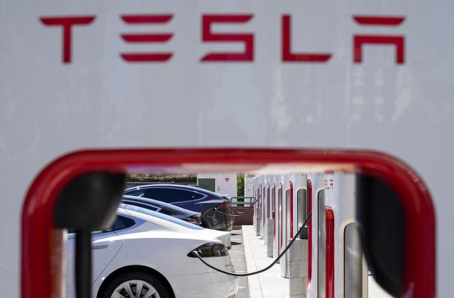 File - Tesla vehicles charge at a station in Emeryville, Calif., Wednesday, Aug. 10, 2022. Tesla reports earnings on Wednesday, Oct. 18, 2023 (AP Photo/Godofredo A. Vásquez, File)
