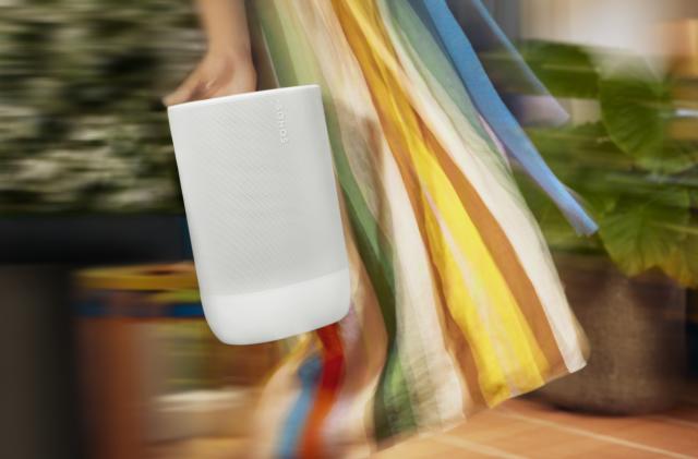 The Sonos Move 2 speaker being carried by a person in a colorful dress.